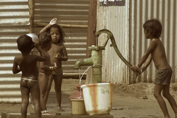 Children filling water from a handpump contaminated by the toilets and stagnant washing waters nearby at Akkaraipettai Temporary camps in Nagapattinam, around 345 kms. south of Madras, India, Wednesday 1st March 2005.  TO GO WITH MR.RAJESH MAHATRA'S STORY.  (AP Photo M.Lakshman)